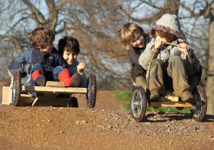Kids playing on the replica Dennis the Menace go-cart